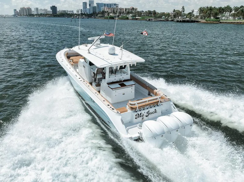 Slide: The Image of 2022 HCB Lujo boat cruising on water with city skyline in background. - 14