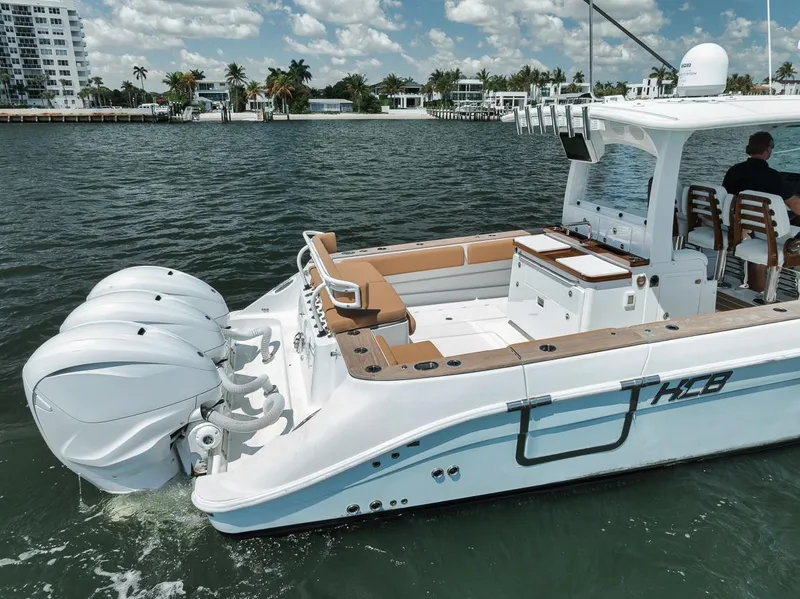 Slide: The Image of 2022 HCB Lujo boat with triple engines cruising on a sunny day. - 16