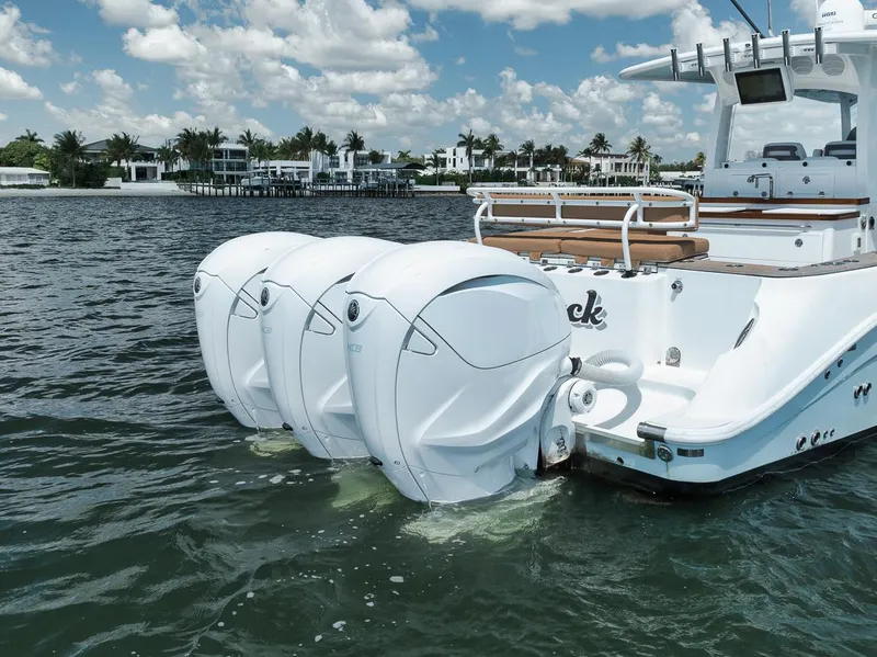 Slide: The Image of 2022 HCB Lujo boat with triple outboard engines on a sunny day. - 17