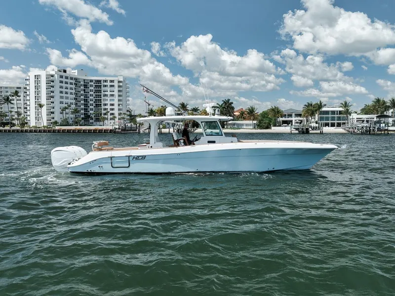 Slide: The Image of 2022 HCB Lujo boat cruising on a sunny day near waterfront buildings. - 4