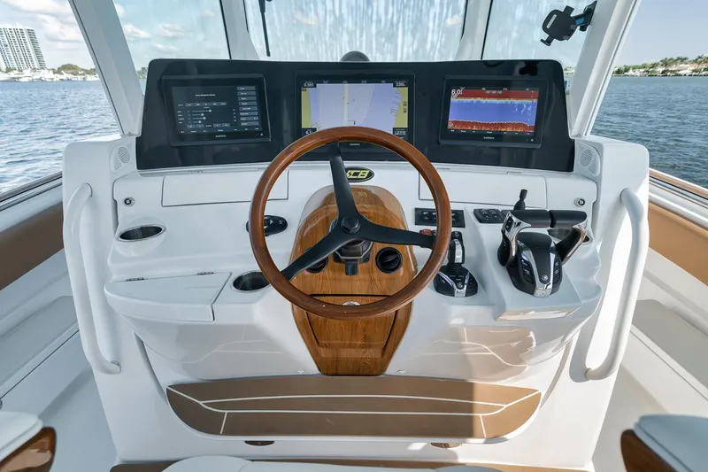 Slide: The Image of Helm of 2022 HCB Lujo boat with modern navigation displays and wooden steering wheel. - 42
