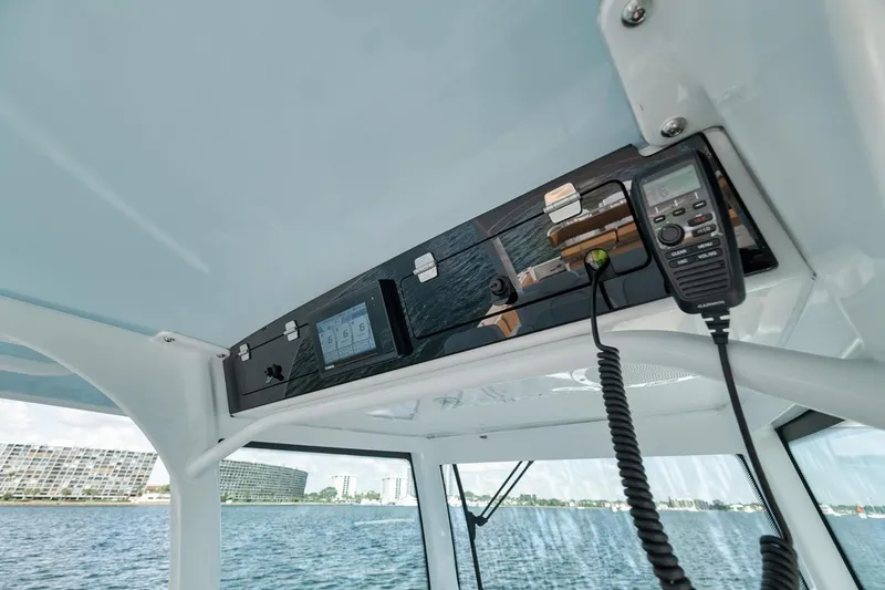 Slide: The Image of 2022 HCB Lujo boat interior with control panel and radio on a sunny day. - 43