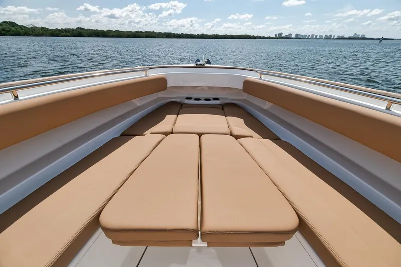 Slide: The Image of Luxurious 2022 HCB Lujo boat with spacious tan seating on open water. - 47