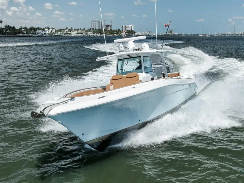 Slide: The Image of 2022 HCB Lujo boat cruising on open water under a clear sky. - 9
