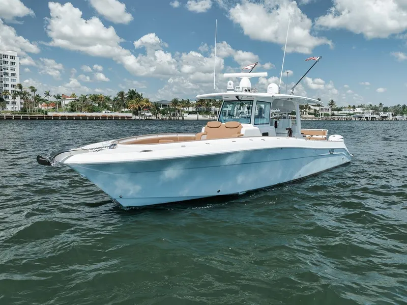 Slide: The Image of 2022 HCB Lujo boat on water under blue sky with clouds. - 2