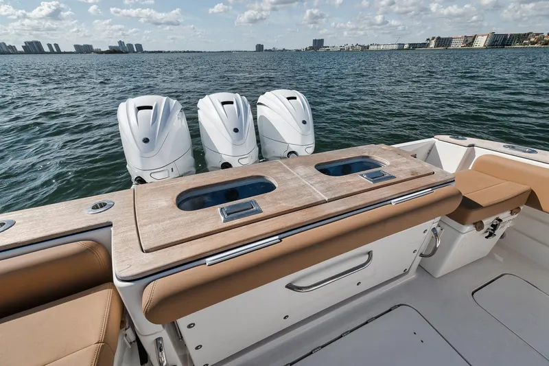 Slide: The Image of 2022 HCB Lujo boat with triple outboard engines on a calm sea. - 26