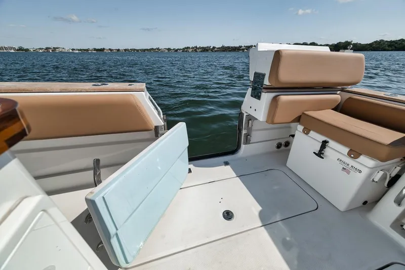Slide: The Image of 2022 HCB Lujo boat interior with open deck, tan seating, and ocean view. - 32
