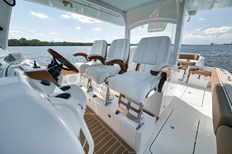 Slide: The Image of Luxury 2022 HCB Lujo boat interior with plush seating and modern helm on open water. - 35