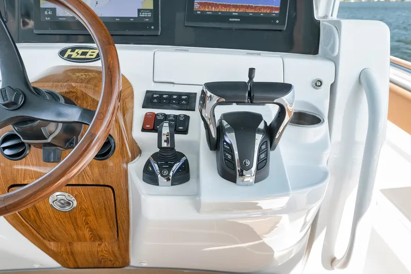 Slide: The Image of Helm of 2022 HCB Lujo boat with modern controls and wooden accents. - 41