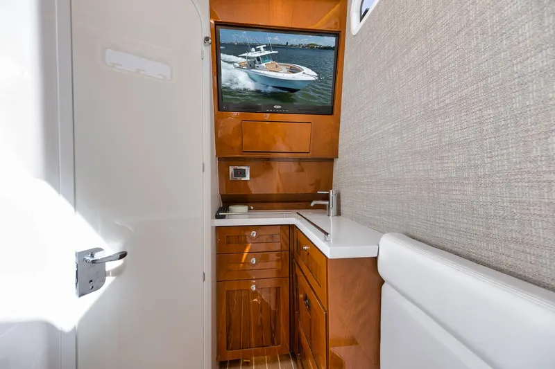 Slide: The Image of Luxurious 2022 HCB Lujo yacht interior with sleek wooden cabinetry and modern amenities. - 48