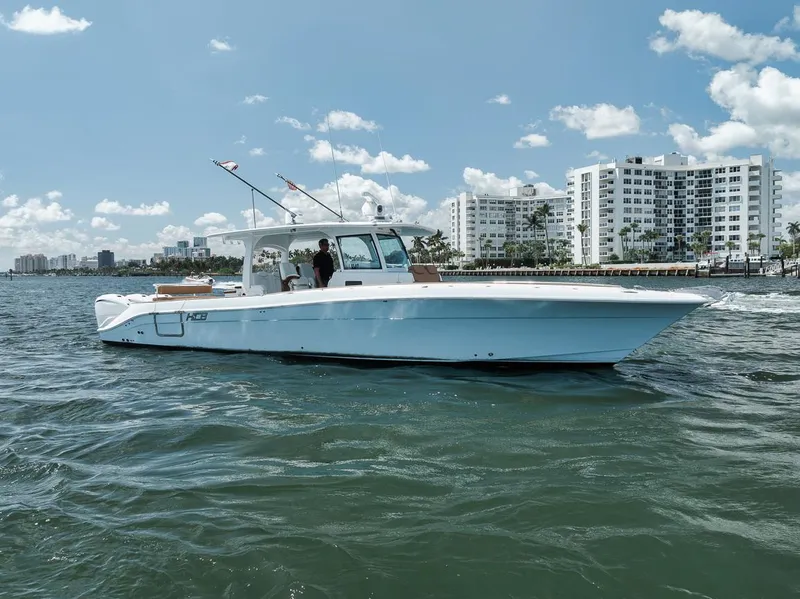 Slide: The Image of 2022 HCB Lujo boat cruising on water near city skyline under blue sky. - 5