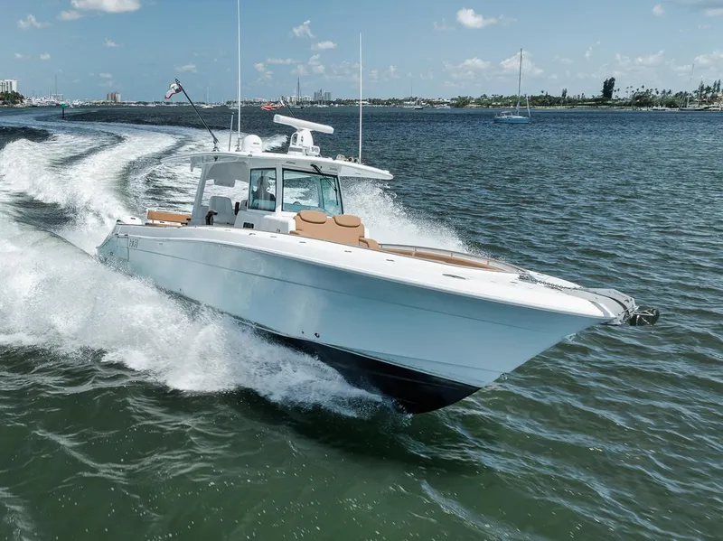 Slide: The Image of 2022 HCB Lujo boat cruising on open water, creating a dynamic wake. - 7