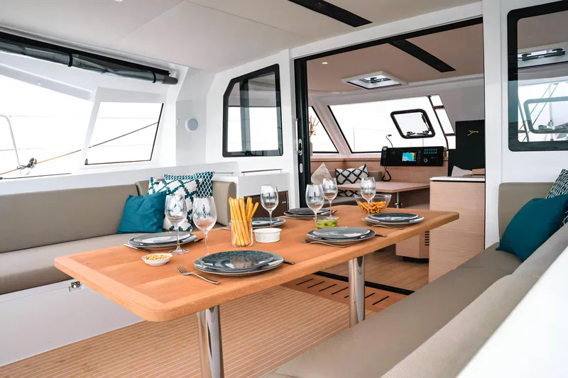 Slide: The Image of Luxurious interior of 2025 Nautitech 40 Open catamaran, featuring elegant dining setup and modern design. - 24