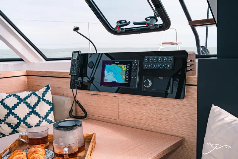 Slide: The Image of 2025 Nautitech 40 Open yacht interior with navigation system and cozy seating area. - 33