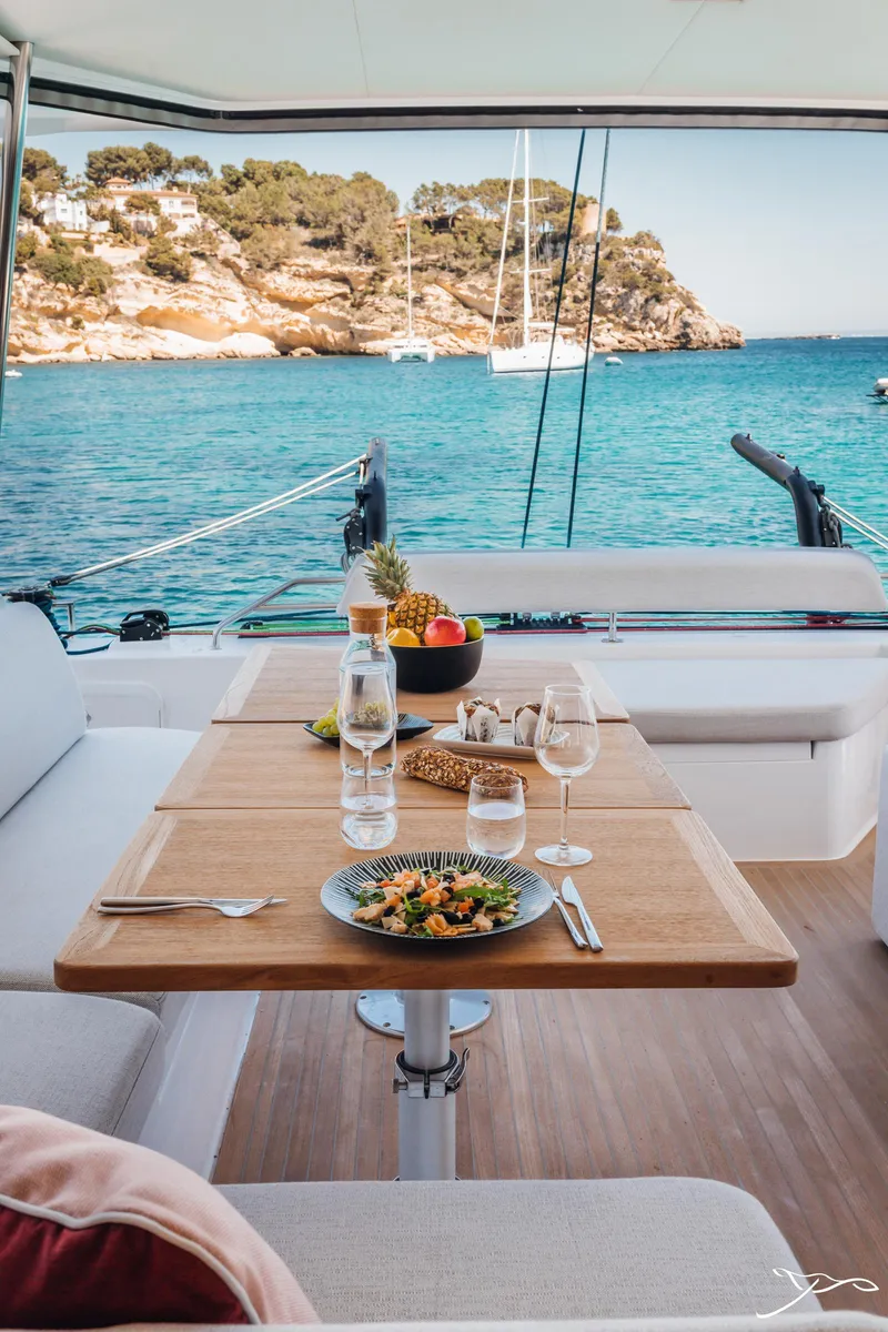 Slide: The Image of Luxury dining on Nautitech 44 Open yacht, 2025 model, with scenic ocean view. - 27