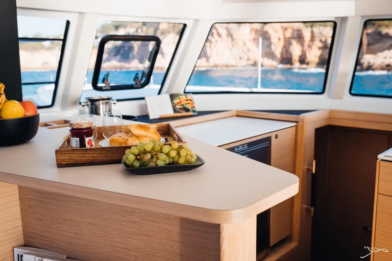 Slide: The Image of Interior of 2025 Nautitech 44 Open yacht with breakfast tray and ocean view. - 36