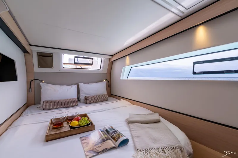 Slide: The Image of Luxurious cabin interior of 2025 Nautitech 44 Open catamaran with cozy bedding and scenic windows. - 43