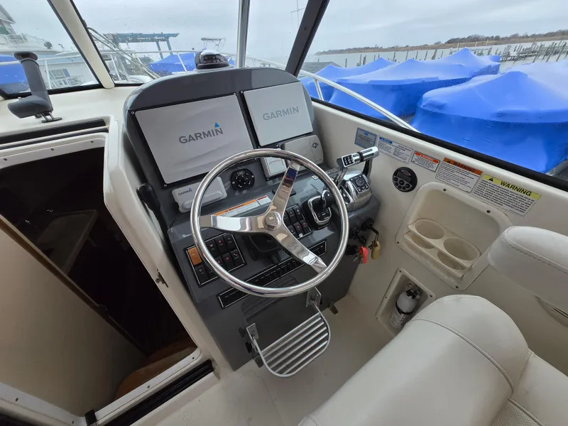 Slide: The Image of Helm of 2006 Pursuit 3370 Offshore boat with Garmin navigation system. - 2