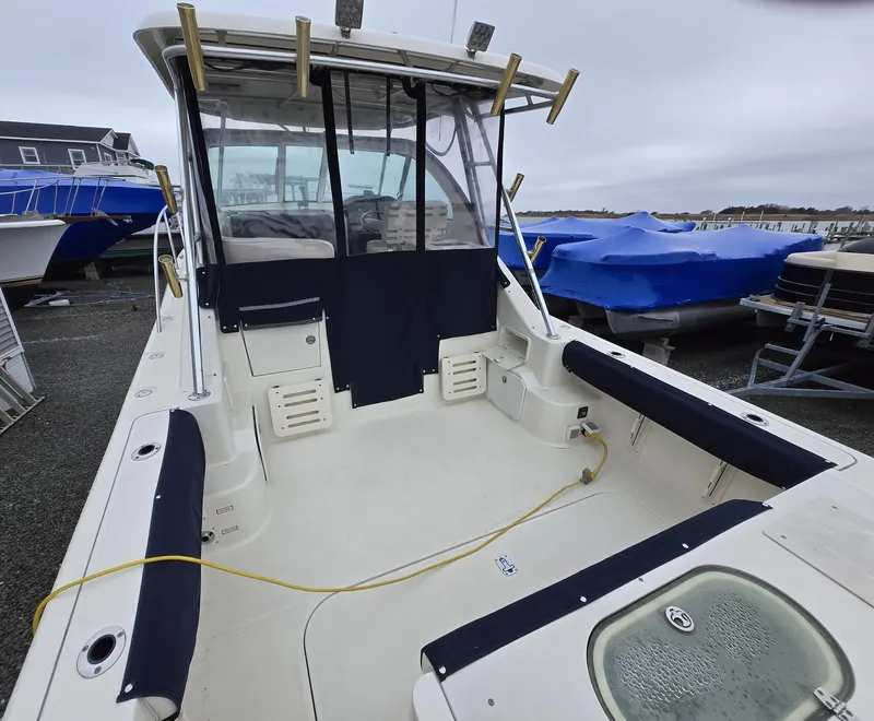 Slide: The Image of 2006 Pursuit 3370 Offshore boat with spacious deck and covered seating area. - 5