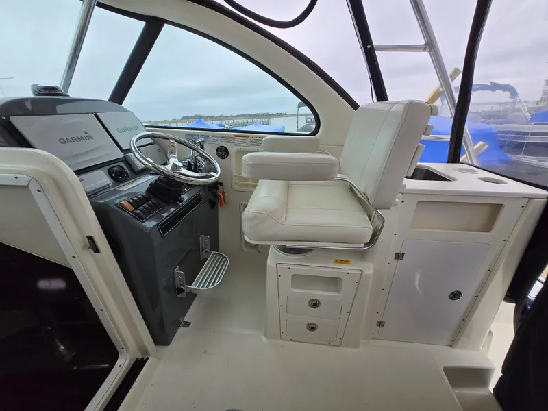 Slide: The Image of 2006 Pursuit 3370 Offshore boat cockpit with steering wheel and captain's chair. - 8