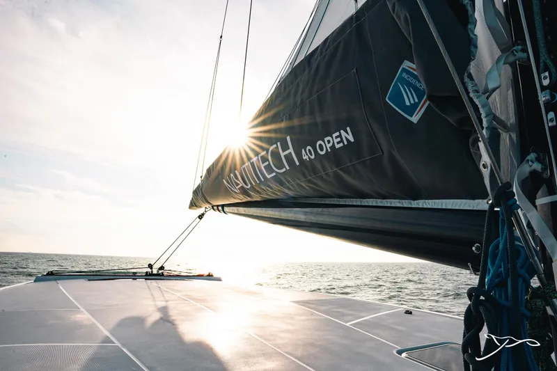 Slide: The Image of 2025 Nautitech 40 Open catamaran sailing at sunset, showcasing sleek design and performance. - 11