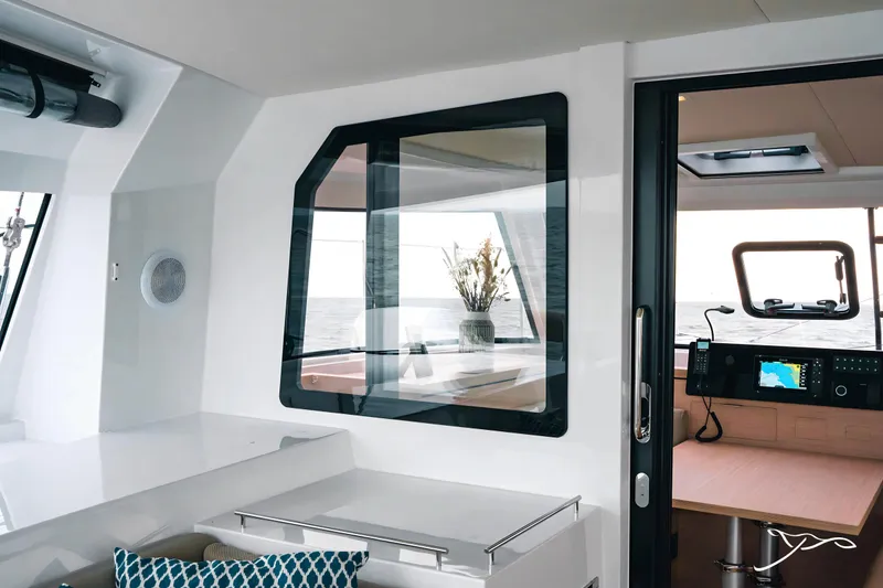 Slide: The Image of Interior of 2025 Nautitech 40 Open catamaran, featuring modern design and navigation equipment. - 25