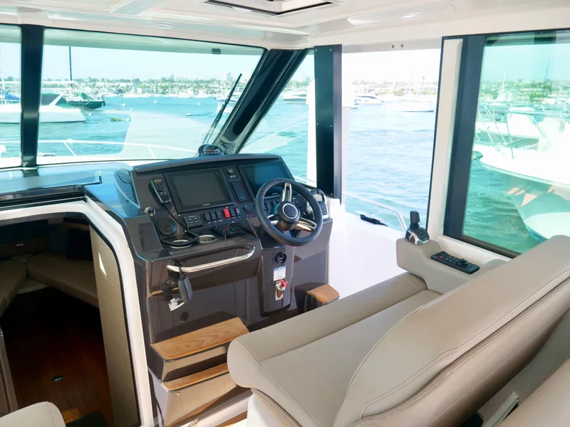 Slide: The Image of 2016 Tiara Yachts Q44 helm with modern controls and ocean view. - 12
