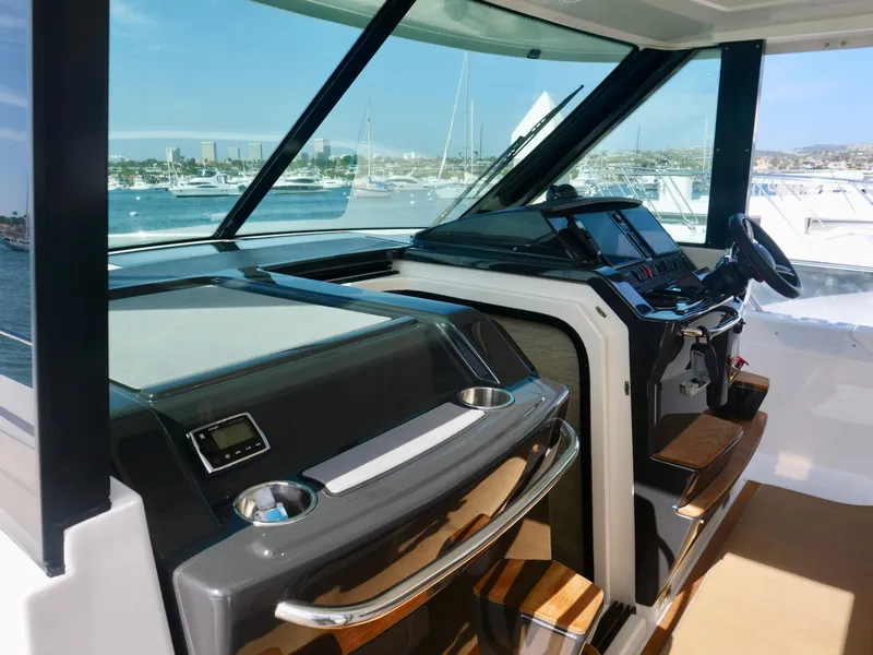 Slide: The Image of 2016 Tiara Yachts Q44 helm with modern controls and panoramic view. - 15