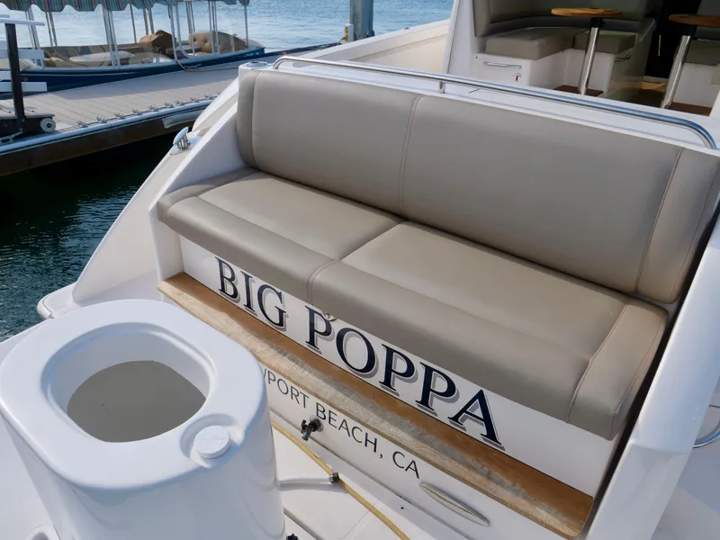 Slide: The Image of 2016 Tiara Yachts Q44 with beige seating, docked in Newport Beach, CA. - 2