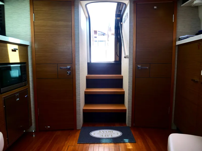 Slide: The Image of Interior of 2016 Tiara Yachts Q44 with wooden flooring and modern cabinetry. - 21