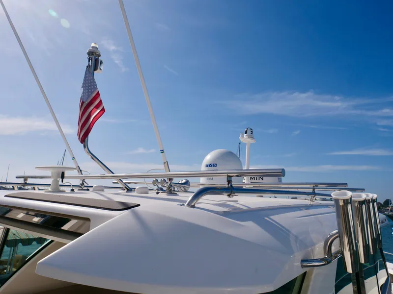 Slide: The Image of 2016 Tiara Yachts Q44 with American flag, clear blue sky background. - 23