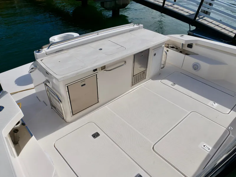 Slide: The Image of 2016 Tiara Yachts Q44 deck with storage and seating area. - 24