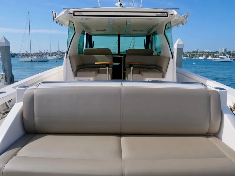 Slide: The Image of 2016 Tiara Yachts Q44 luxury yacht interior with seating, docked at marina. - 28