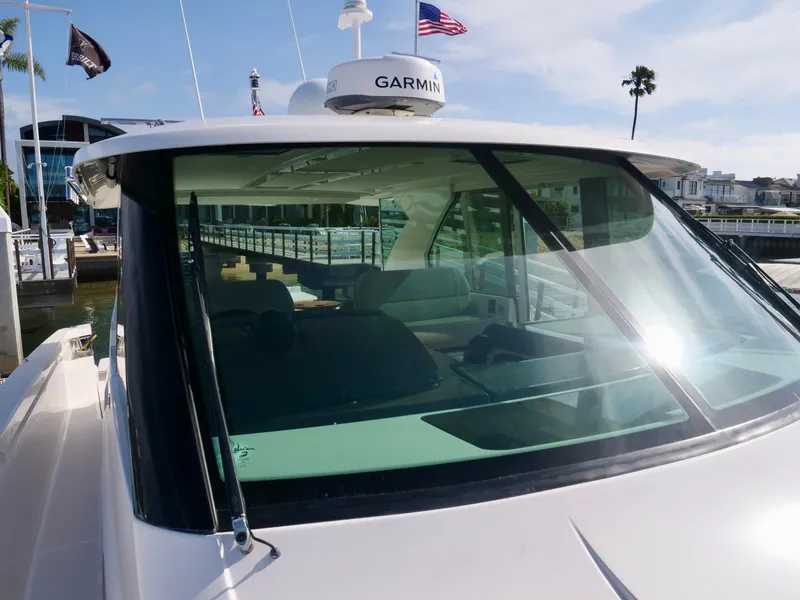 Slide: The Image of 2016 Tiara Yachts Q44 with Garmin equipment, docked at a marina under clear skies. - 30