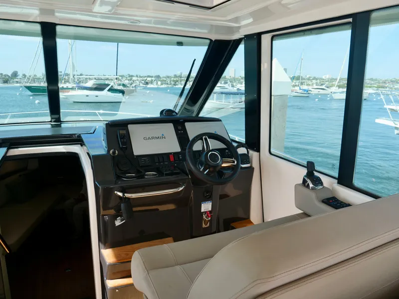 Slide: The Image of Interior view of 2016 Tiara Yachts Q44 helm with Garmin navigation system. - 31
