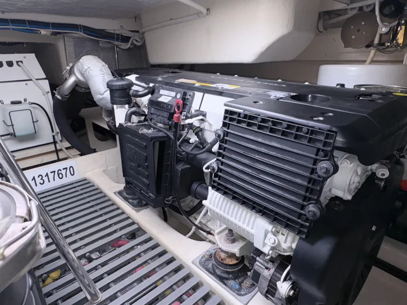 Slide: The Image of Engine room of 2016 Tiara Yachts Q44, showcasing detailed mechanical components. - 32