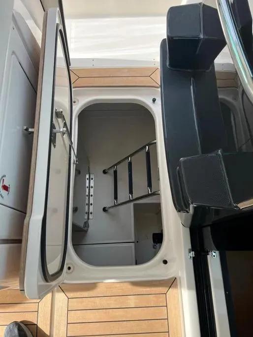 Slide: The Image of 2016 Tiara Yachts Q44 interior hatch with ladder and seating. - 33