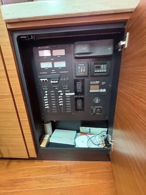 Slide: The Image of Electrical panel inside 2016 Tiara Yachts Q44, featuring various switches and controls. - 36