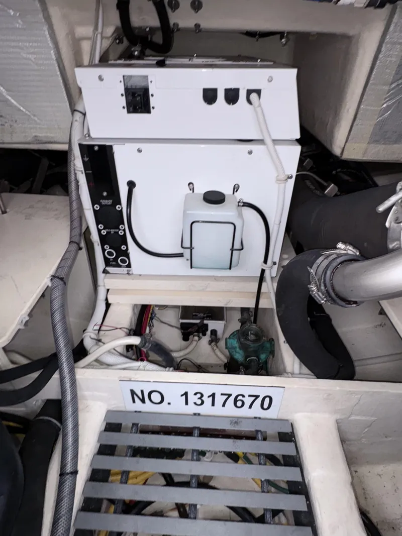 Slide: The Image of Engine compartment of 2016 Tiara Yachts Q44 with equipment and serial number 1317670. - 38