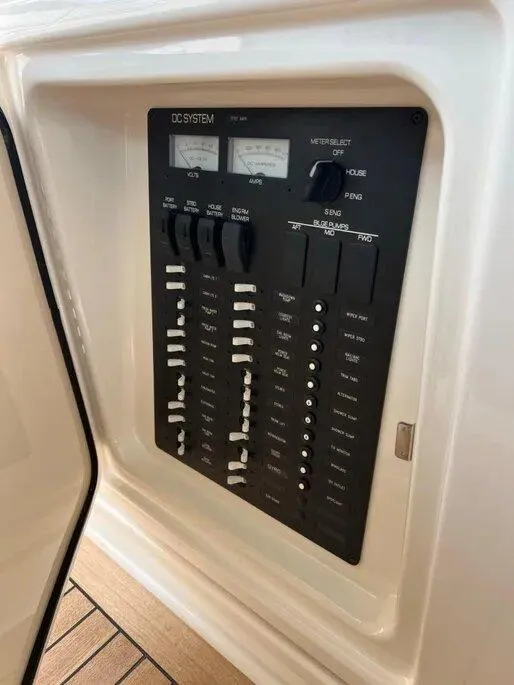 Slide: The Image of 2016 Tiara Yachts Q44 DC system panel with switches and gauges. - 40