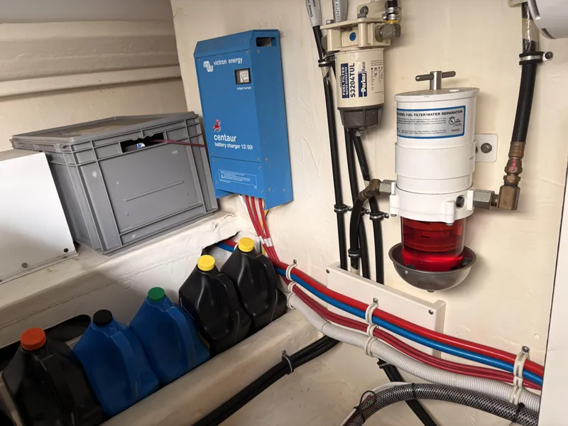 Slide: The Image of Engine room of 2016 Tiara Yachts Q44 with fuel filter and battery charger. - 42