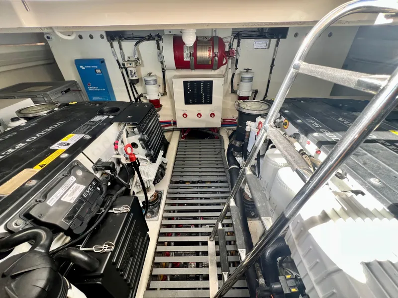 Slide: The Image of Engine room of 2016 Tiara Yachts Q44, featuring dual engines and safety equipment. - 43