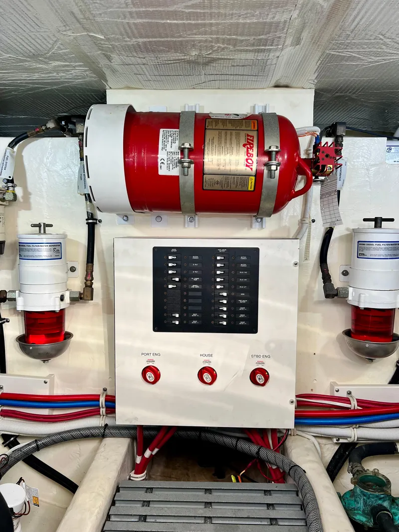 Slide: The Image of Engine room of 2016 Tiara Yachts Q44 with fire suppression system and control panel. - 45