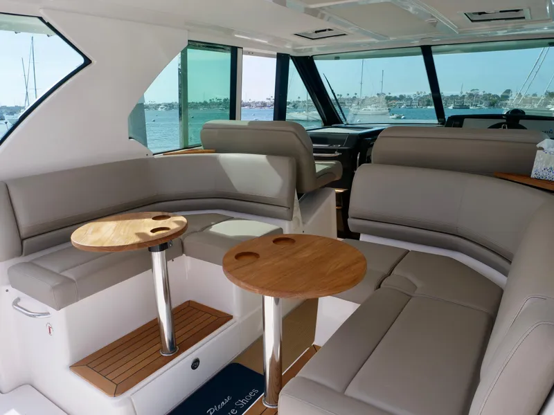 Slide: The Image of Interior of 2016 Tiara Yachts Q44 with elegant seating and wooden tables. - 7