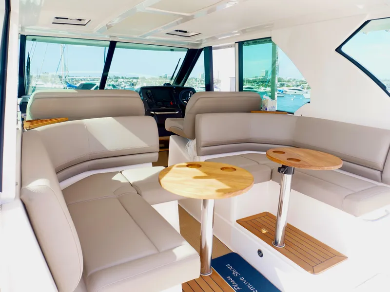 Slide: The Image of Luxurious interior of 2016 Tiara Yachts Q44 with plush seating and wooden tables. - 8