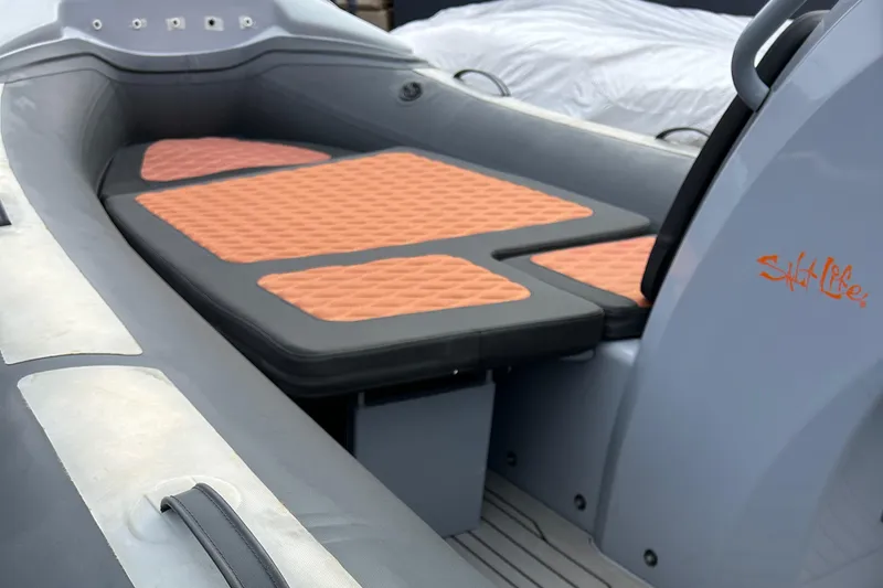 Slide: The Image of 2021 Highfield Sport 460 boat interior with orange cushioned seating. - 9