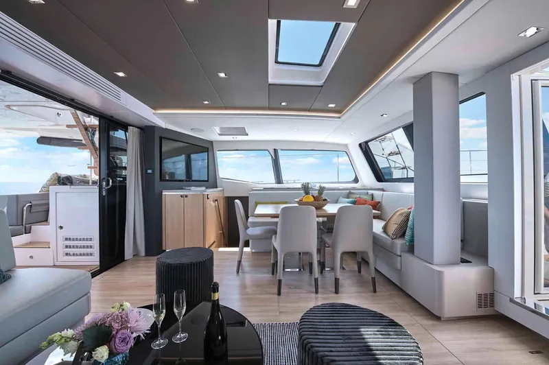 Slide: The Image of Luxurious interior of 2025 Privilege Signature 580 yacht with modern dining area and panoramic windows. - 36