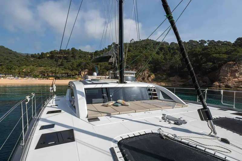 Slide: The Image of Luxury Privilege Signature 580 yacht, 2025 model, anchored near scenic coastline. - 9