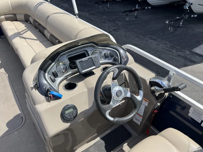 Slide: The Image of 2020 Sun Tracker Party Barge 24 DLX helm with steering wheel and control panel. - 10