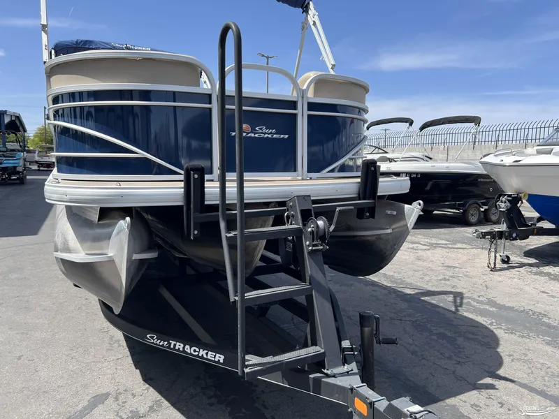 Slide: The Image of 2020 Sun Tracker Party Barge 24 DLX pontoon boat on trailer in a parking lot. - 13